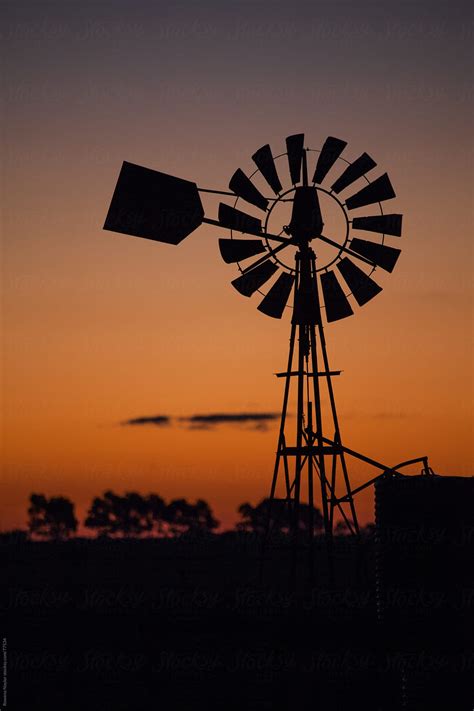 Old Farm Windmill At Sunset By Stocksy Contributor Rowena Naylor