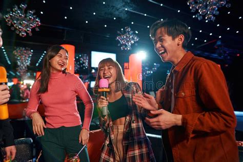 Asian Friends Having Fun While Singing Karaoke On Night Party At The Bar Stock Image Image Of