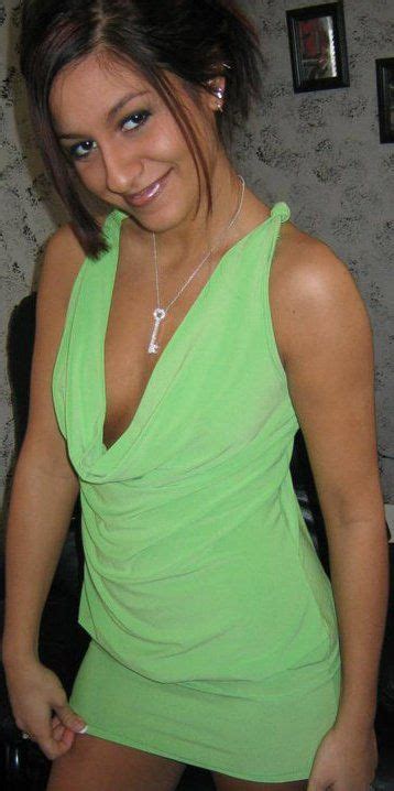 A Woman In A Green Dress Posing For The Camera