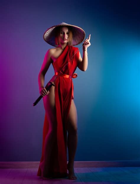 Premium Photo Sexy Woman In A Red Cape And An Asian Hat With A Katana