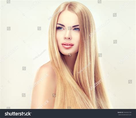 Beautiful Blonde Woman With Long Healthy Straight And Shiny Hair