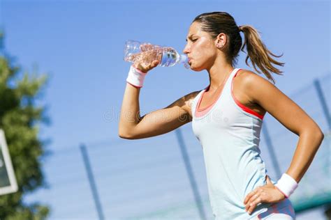 Young Beautiful Athlete Drinking Water After Exercising Stock Photo