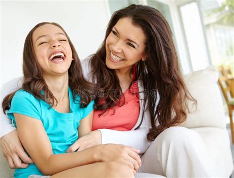 Having Fun With Mom A Mother Tickling Her Daugher While Her Daughter