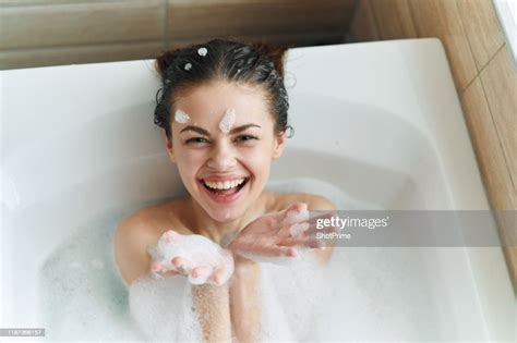 Young Beautiful Woman Is Lying In The Bathroom With Foam And Playing With Foam And Bubbles High