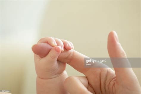 Mother And Newborn Baby Holding Hands High Res Stock Photo Getty Images