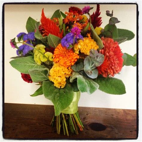 Artificial lambs ear, eucalyptus and berries create a bouquet of greenery. August Bridal Bouquet with lambs ear, ageratum, marigolds ...