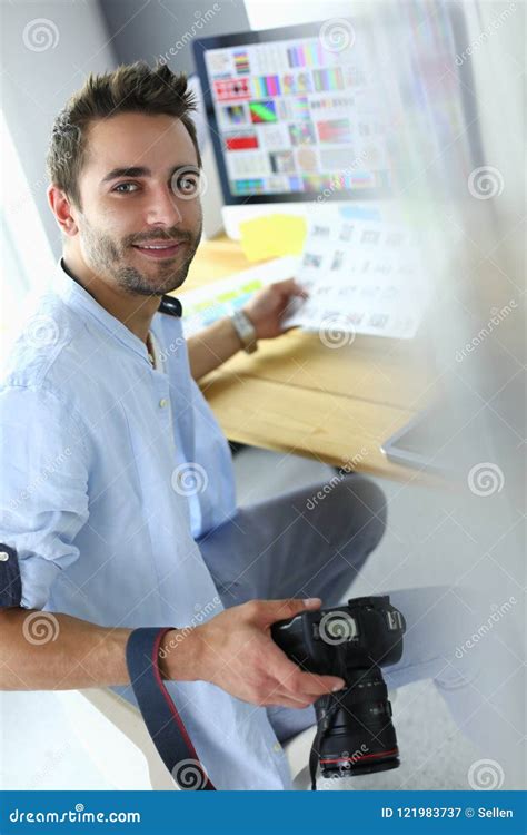 Portrait Of Young Designer Sitting At Graphic Studio In Front Of Laptop