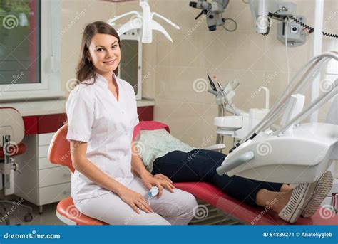 Female Dentist Near The Patient In The Dental Chair Stock Image Image