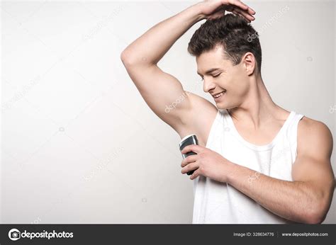 Smiling Man White Sleeveless Shirt Applying Deodorant Underarm Isolated Grey Stock Photo