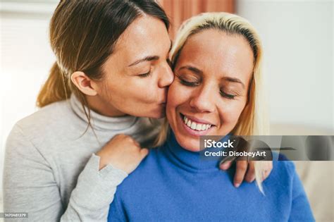 happy gay couple having tender moment at home lgbt love concept main focus on right woman eye