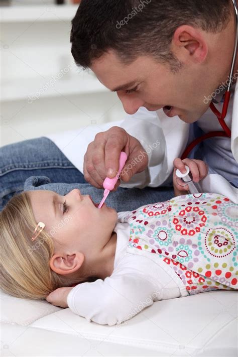 Doctor Checking Little Girls Temperature — Stock Photo © Photography33