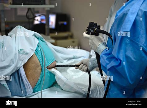 Doctor Operating An Endoscope To Perform A Colonoscopy Examination