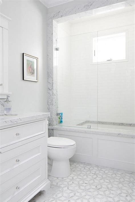 Build your dream bathroom with matching mosaics. marble mosaic floor tiles, white vanity, marble bath ...