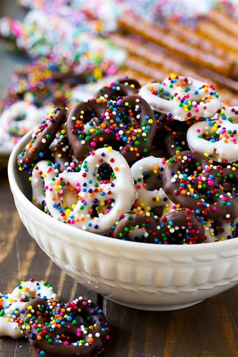 A Bowl Of Chocolate Covered Pretzels Decorated With Rainbow S