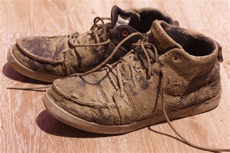 Dirty Shoes With Dried Mud On The Floor Stock Photo Image Of