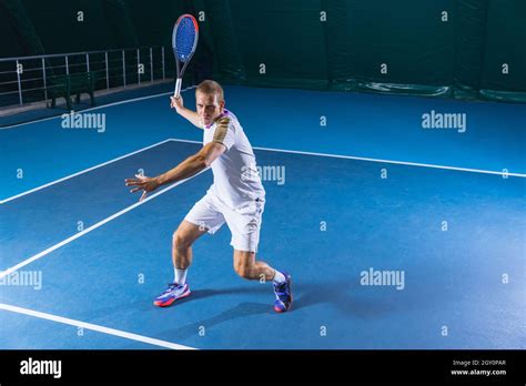 Full Length Portrait Of Professional Tenis Player Man Training Over
