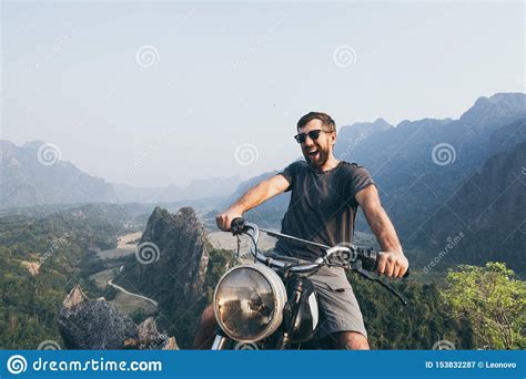 Caucasian Young Man Riding Motorcycle on Top of the Mountains in Vang ...