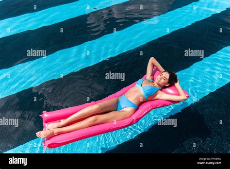 Girl In Bikini Lying On Inflatable In Outdoor Swimming Pool Stock My