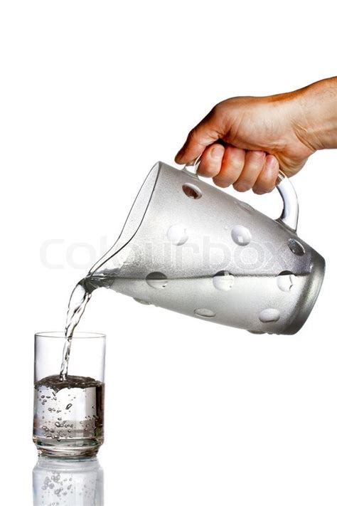 Hand Pouring Water From Jug To Glass Stock Image Colourbox