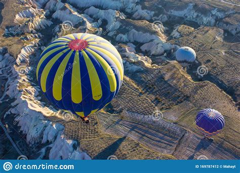 Hot Air Balloons Landing During Sunrise After Flying Over Colourful