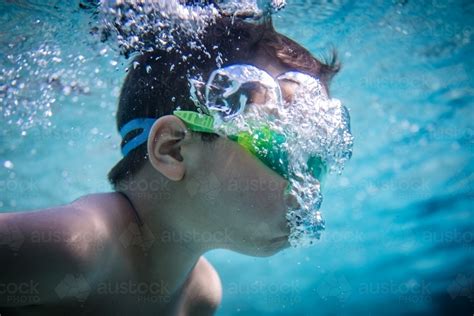 Image Of Mixed Race Boy Swims And Plays In A Backyard Pool Austockphoto