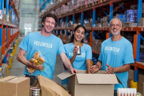 Volunteers Packing Eatables In Cardboard Box Stock Photo By