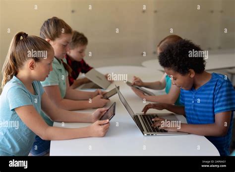 Group Of Elementary School Kids Using Computers Stock Photo Alamy