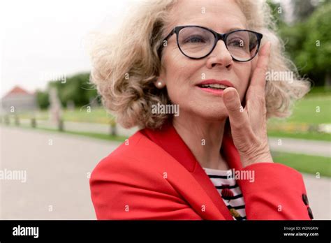 Senior Woman 67 Years Old Touching Her Head In Park In Nymphenburg Munich Germany Stock