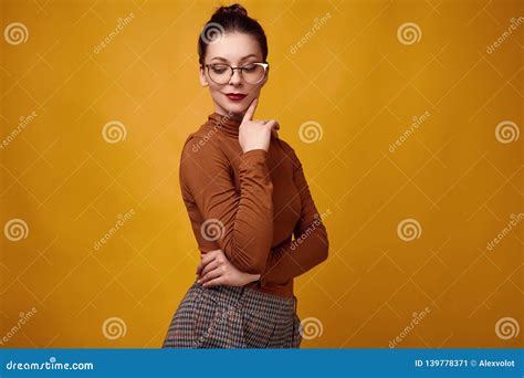 Fashion Brunette Woman Wearing Turtleneck And Glasses On Yellow
