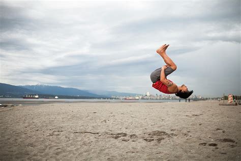 Man Doing Back Flip At Beach Photograph By Christopher Kimmel Pixels