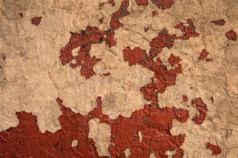 An Old Texture Peeling Patches Of Red Paint On A Gray Concrete Wall