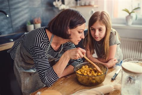 Premium Photo Mother And Daughter Tasting Apple Pie Filling