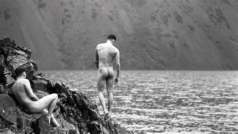 Black And White Rearview Two Naked Guys On The Rocks At The Waters Edge Gallery Of Men