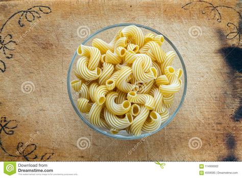 Macaroni Rigati Glass Bowl With Pasta On A Wooden Board Caused By A