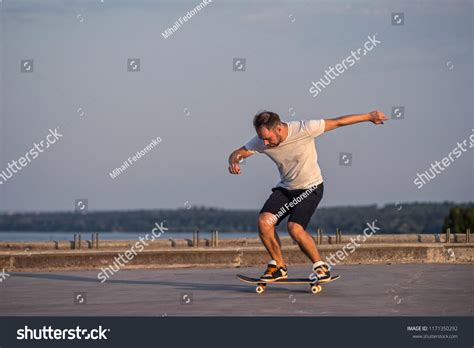 Young Skateboarder Performing A Flip Trick In A Royalty Free Stock