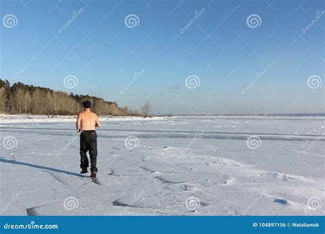 Man In A Cap With A Naked Torso Running Across The Ice Of A Frozen River Stock Photo Image Of