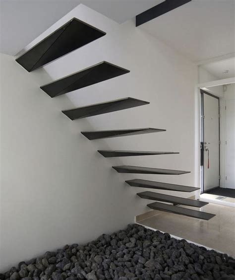 A Modern Staircase Made Out Of Black And White Stairs