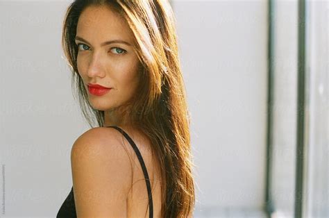 portrait of beautiful woman with red lips looking at camera del colaborador de stocksy amor