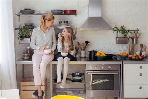 Mother And Daughter Eating Together In The Kitchen By Lumina Kitchen