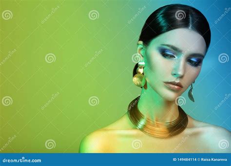 High Fashion Model Woman In Colorful Bright Lights Posing In Studio