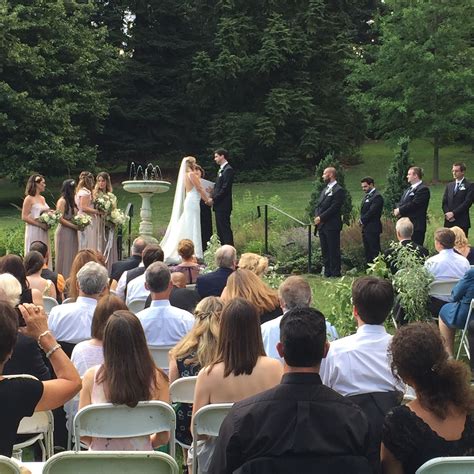 A Bride And Groom Are Standing At The Alter In Front Of An Outdoor