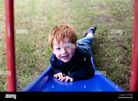 Boy Playing On Slide Stock Photo Alamy