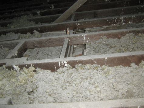 Sprayed 'limpet' asbestos on the underside of an asbestos cement roof. Asbestos Testing Info - Loose Fill Asbestos Insulation