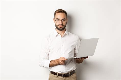 Premium Photo Business Handsome Manager Working On Laptop Holding