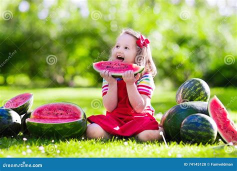 Little Girl Eating Watermelon In The Garden Stock Photo Image Of