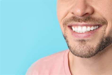 Smiling Man With Perfect Teeth On Color Background Closeup Space For