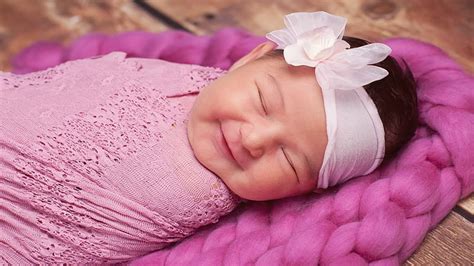 Smiley Cute Closed Eye Baby Is Covered With Pink Netted Towel And