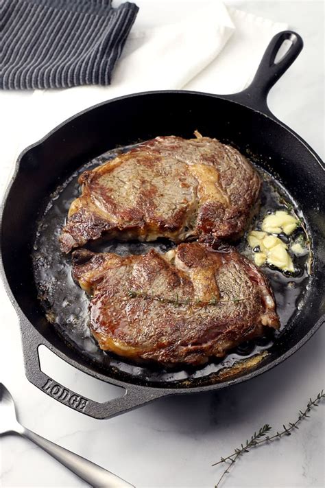 They can recover from nearly any abuse. Cast iron pan with two steaks. in 2020 | Rib eye steak ...