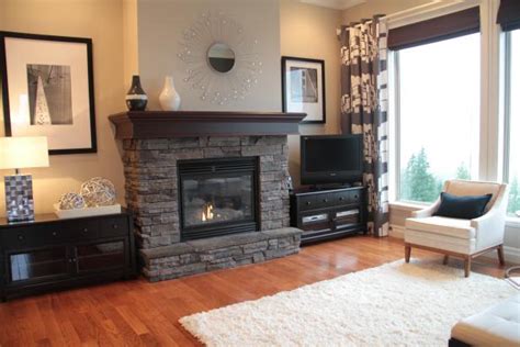 Elegant living room with red sofa, fireplace, tv and many windows. Neutral Living Room With Gray Stacked Stone Fireplace | HGTV