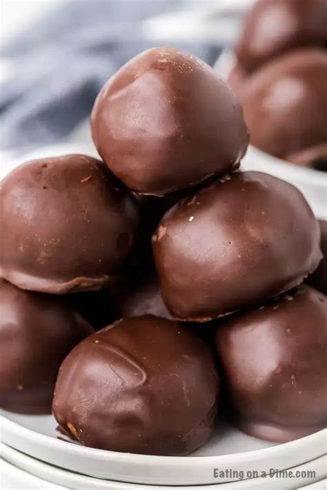 Chocolate Balls Stacked On Top Of Each Other In A White Bowl